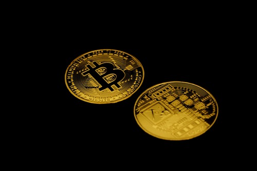 BNB and Ethereum (ETH) cryptocurrency coins side by side